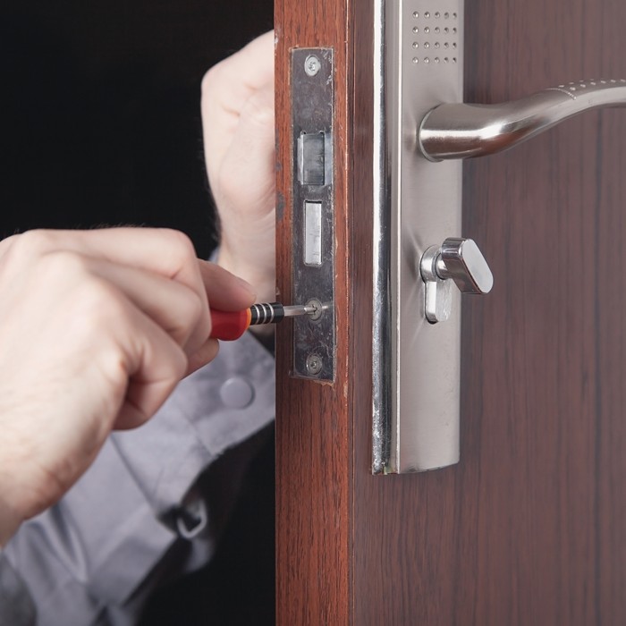 Close-up of a phone with locksmith contact number displaye