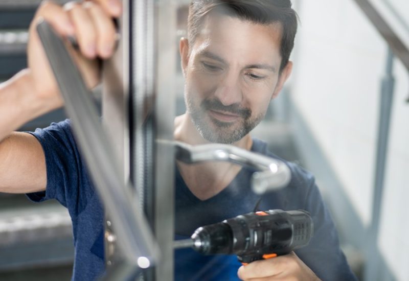 Professional unlocking a car door during lockout servic